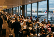 Passengers seated and walking in busy airport terminal at gate B43 with planes outside